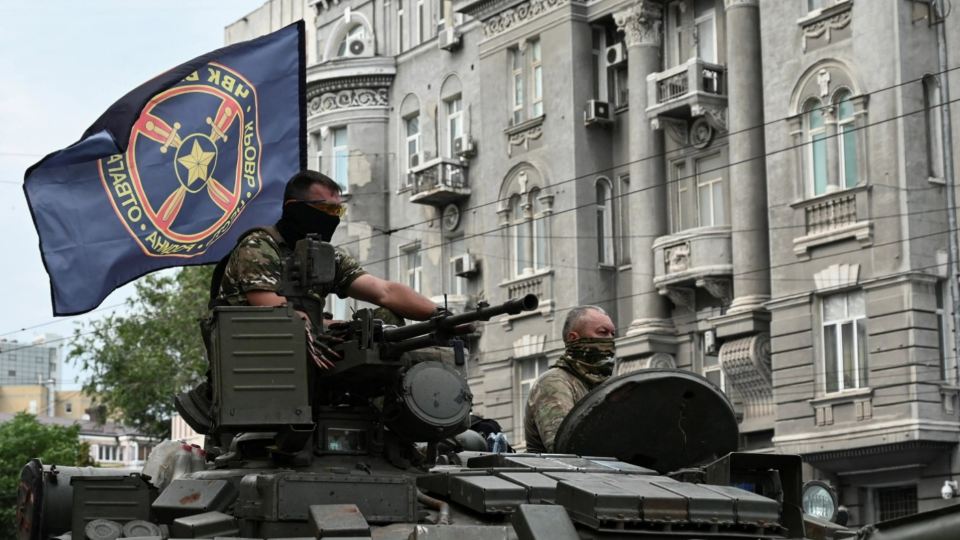 Wagner Group mercenaries ride on a tank during their June 2023 revolt