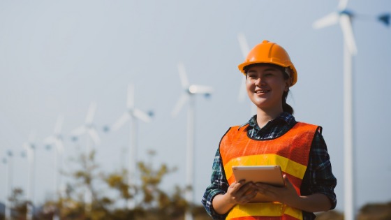 Woman in protective gear holding iPad