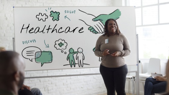 Woman talking about healthcare to a group of people