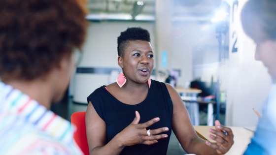 Woman talking to colleagues