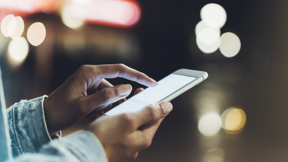 Woman uses smartphone in city 