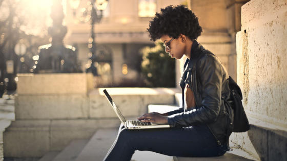 Woman working on laptop outside