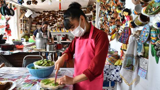 Women work in a restaurant in the town of Nopaltepec