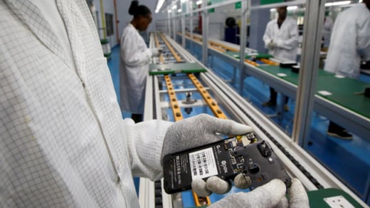Workers assemble an Open G smartphone at the factory where the phones are manufactured in Grand Bassam, Ivory Coast