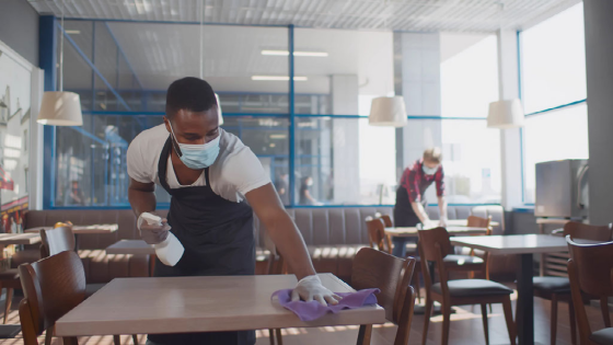 Workers clean tables at cafe