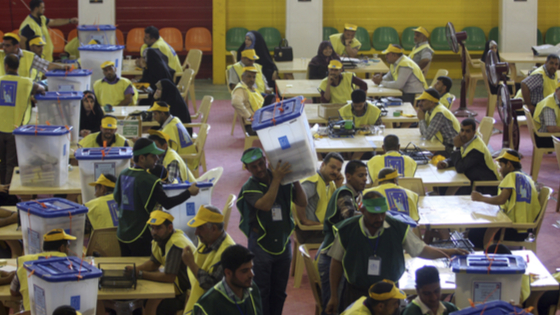 Workers from Iraqi Independent High Electoral Commission (IHEC) count votes at an analysis centre in Kerbala