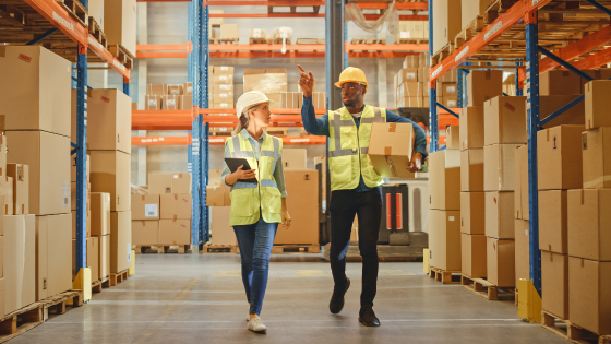 Workers in conversation with each at warehouse