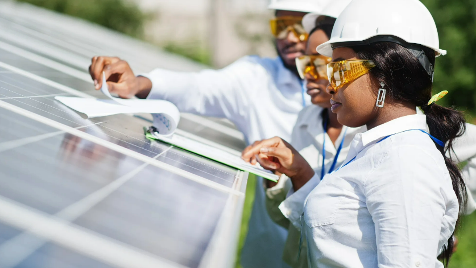 Workers inspect solar panels