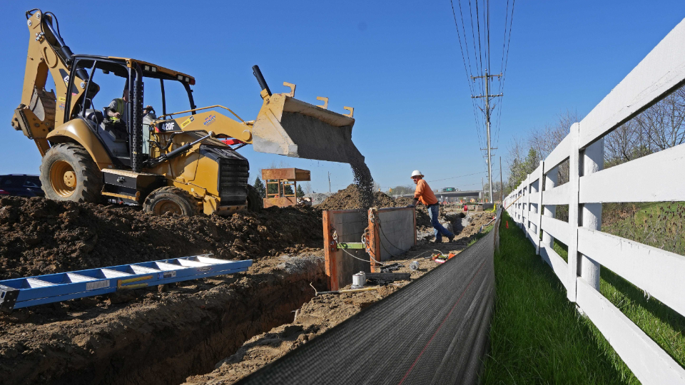 Workers lay fiber optic cable piping in New Albany near the new Intel chip manufacturing plant.