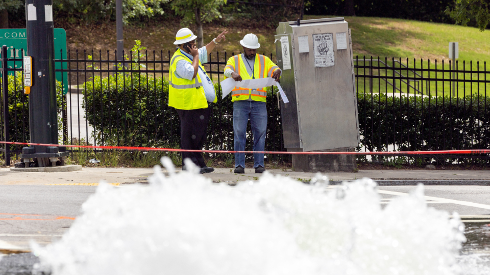 Workers look to resolve a water main break at Joseph E. Boone Boulevard and James P. Brawley Drive in Atlanta on May 31, 2024.