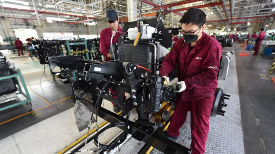 Workers on the production line of a truck assembly workshop at a JAC Motors Group Co LTD factory in east China
