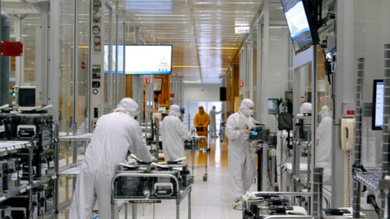 Workers work inside the clean room of U.S. semiconductor manufacturer SkyWater Technology Inc 