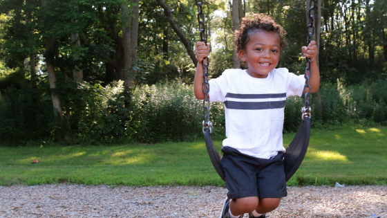 Young boy on park swing