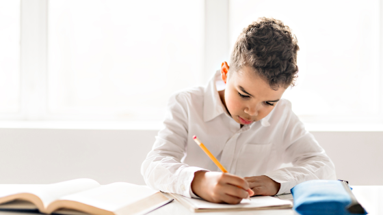 Young boy working in classroom