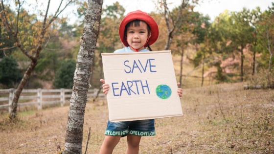 Young girl holding a Save Earth sign