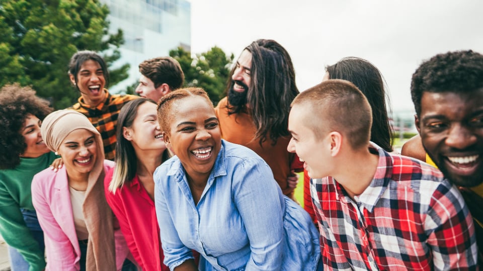 Young people having fun outdoors laughing together.