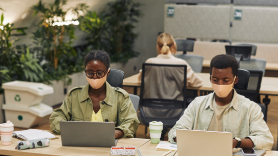 Young workers at desk amid COVID-19 pandemic