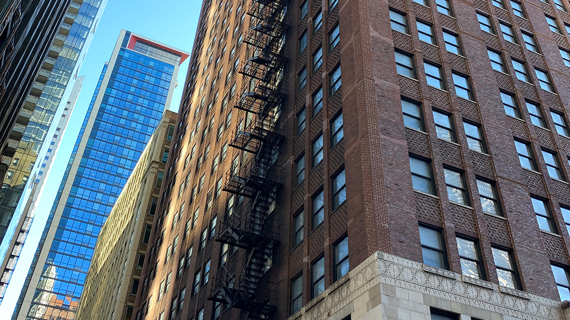 Shot of tall, brick buildings from a street view in Chicago.